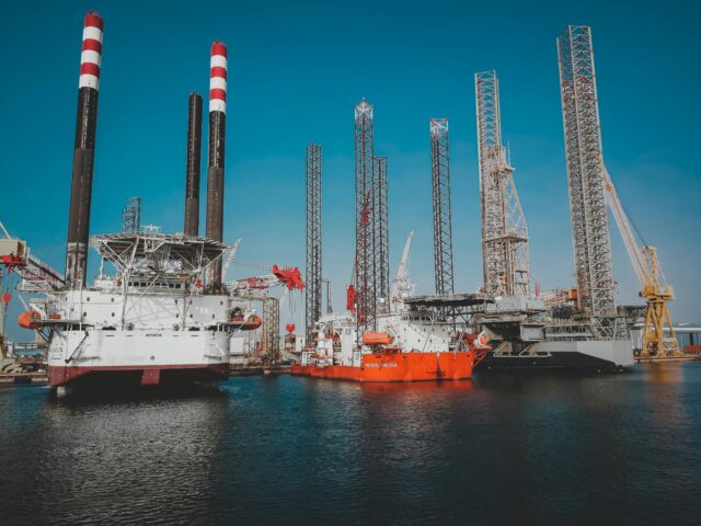 Offshore rigs docked in calm waters.