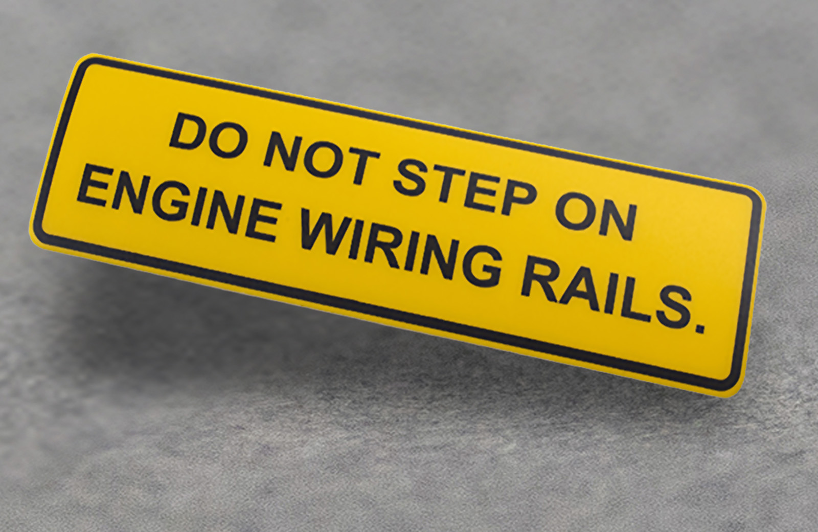 A yellow plastic warning label.